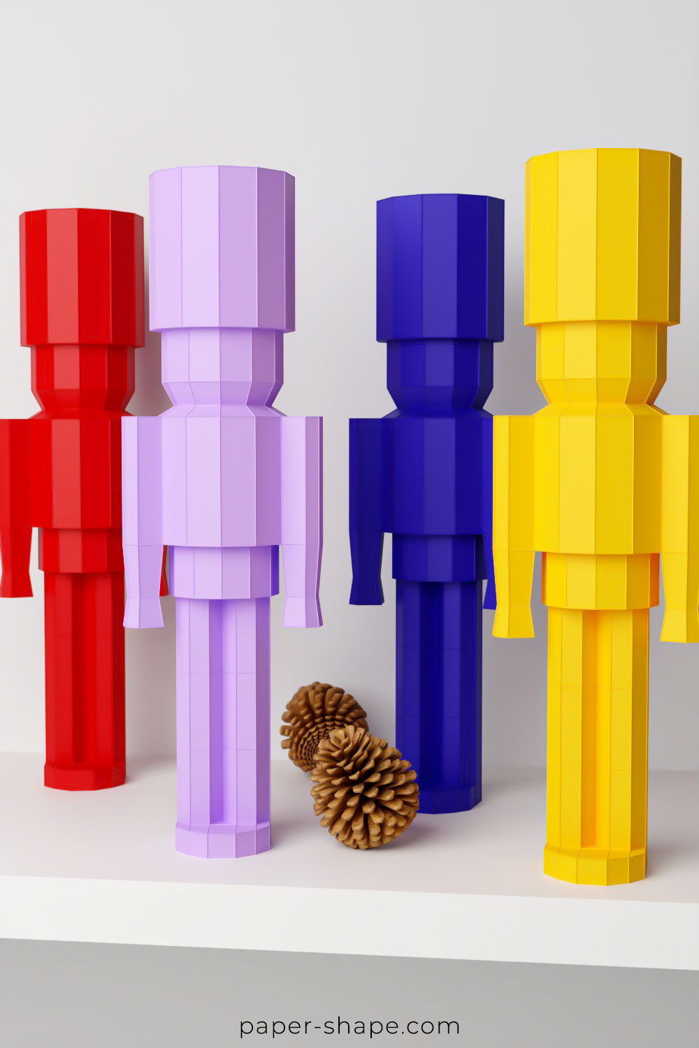 Papercraft nutcracker in red, light purple, royal blue and yellow on a white shelf board