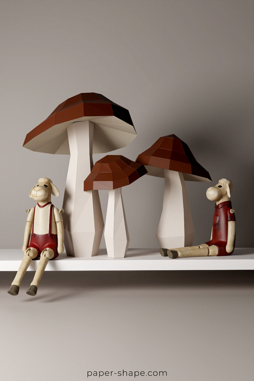 Papercraft mushrooms placed together with wooden mooses on a shelf