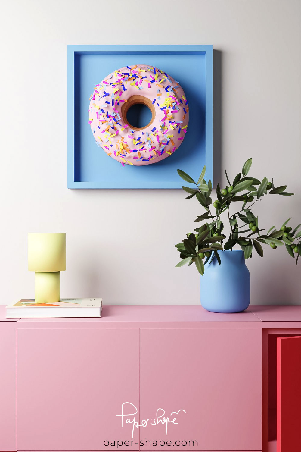 Bunter selbstgemachter Papier-Donut auf blauem Hintergrund bringt Farbtupfer in minimalistisch eingerichtete Räume.