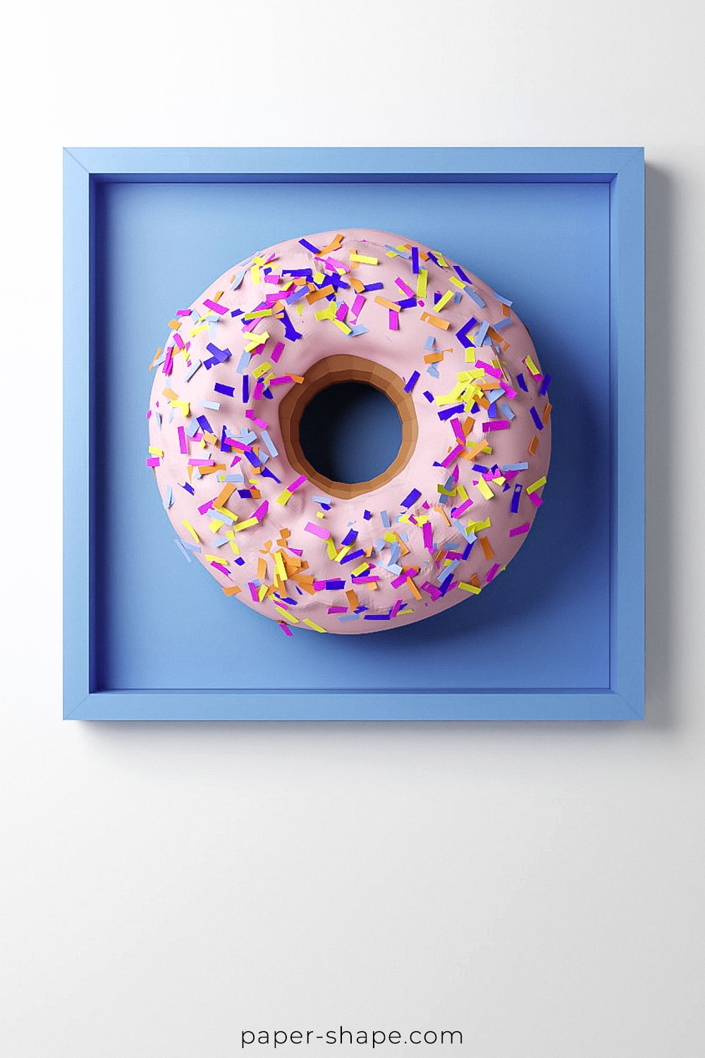 DIY Paper donut with pink icing and colourful sprinkles in a blue IKEA picture frame as a wall decoration.